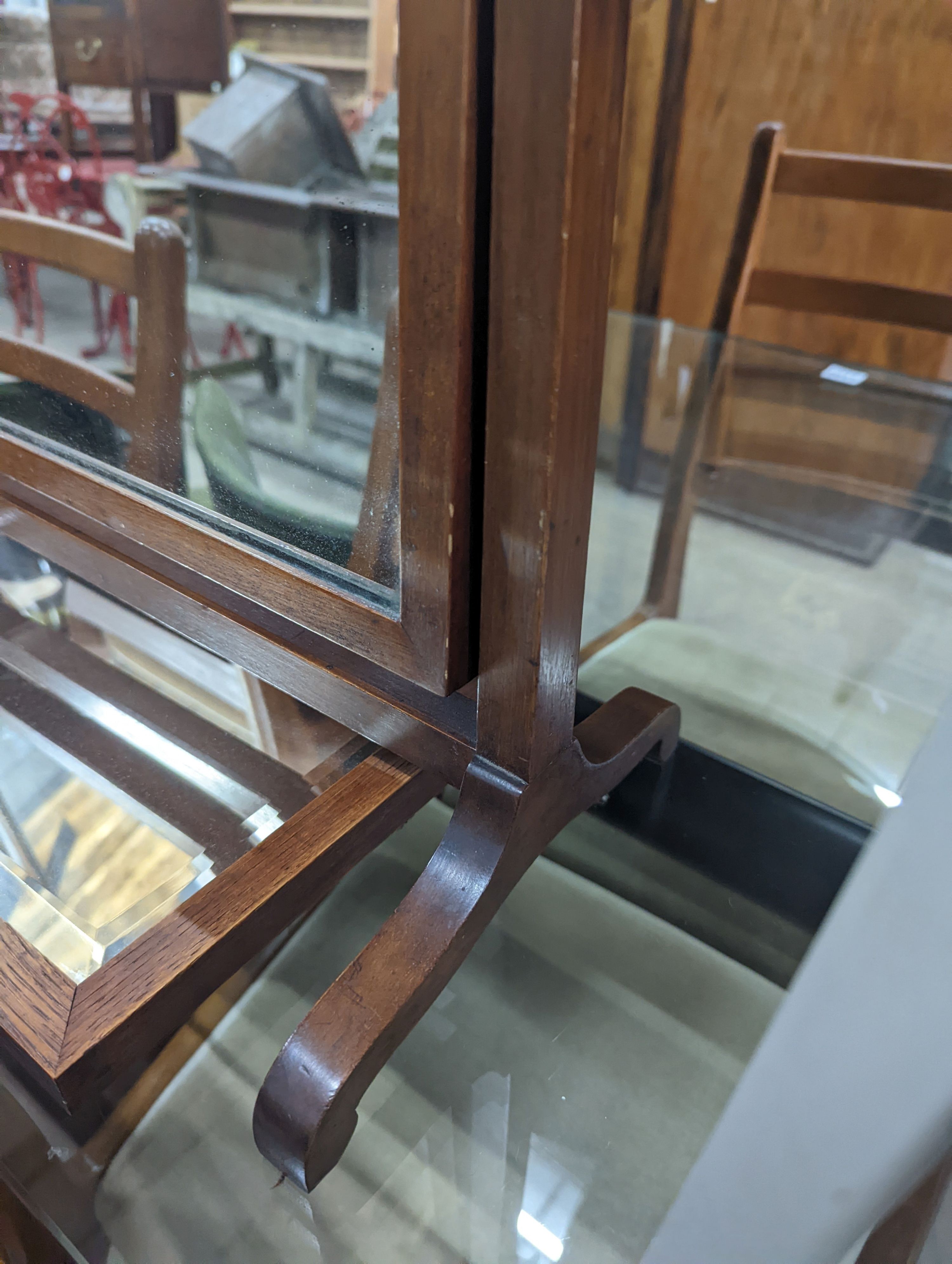 An Edwardian mahogany skeleton framed toilet mirror, width 54cm, depth 23cm, height 48cm together with a wall mirror